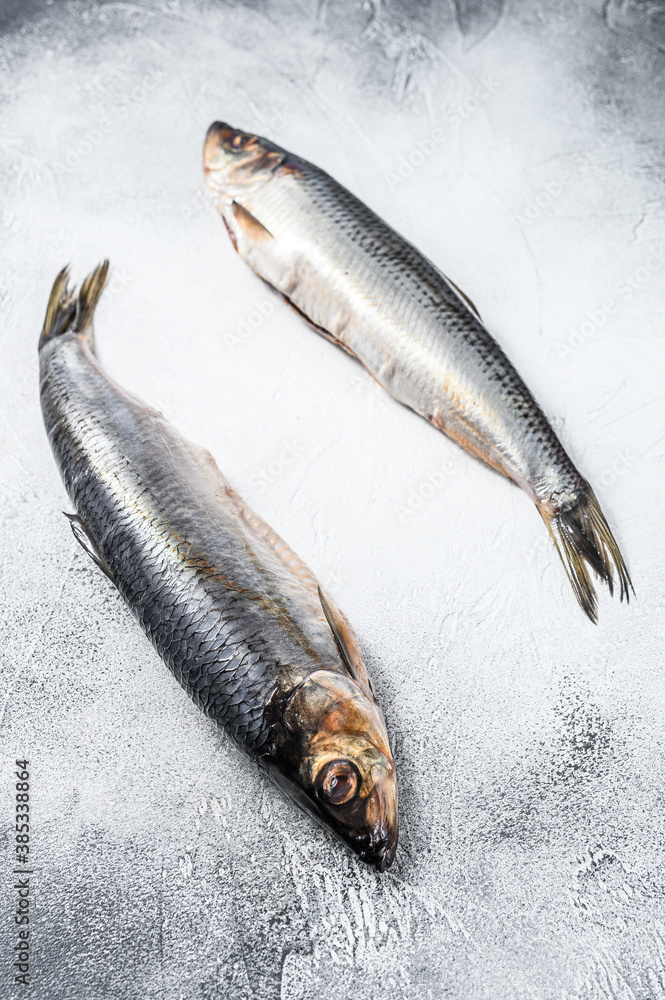 Pickled  whole Nordic herring. Gray background. Top view