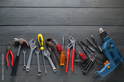 Working tools on black wooden background.