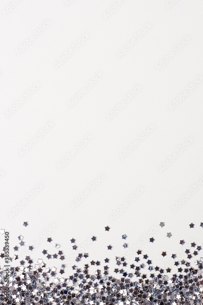 Silver confetti on white. Colorful Christmas or holiday background