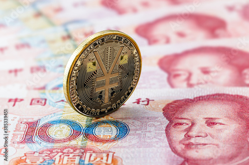 one hundred yuan banknotes, next to an e-RMB gold coin, digital version of the yuan. Concept of new digital currency of the popular republic of china photo