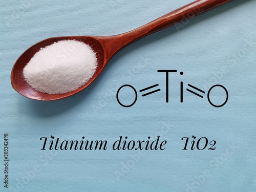 Structural chemical formula of titanium dioxide molecule with white titanium dioxide (TiO2) powder for cosmetic. It is inorganic chemical compound, widely used as a commercial white pigment. photo
