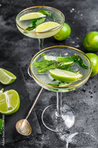 Mojito cocktail, Refreshing mint with rum and lime, cold drink or beverage. Black background. Top view