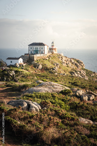 Views of Finisterre lighthouse from the cliff at the end of the world. photo