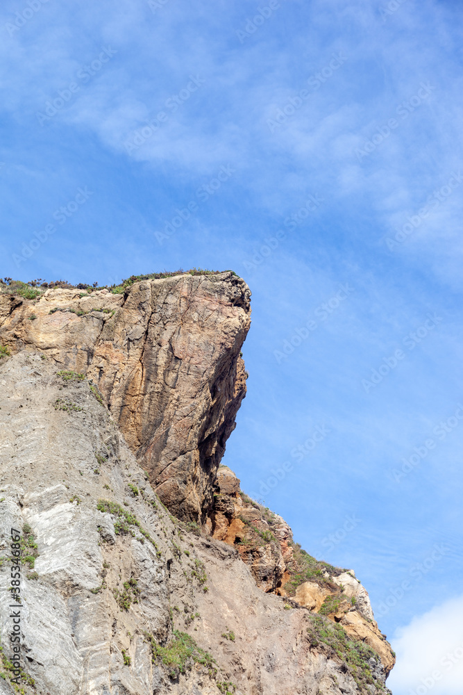 Cliff  on a beach, blue sky