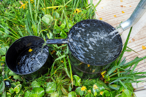 Obraz na plátně System for collecting rainwater from two barrels