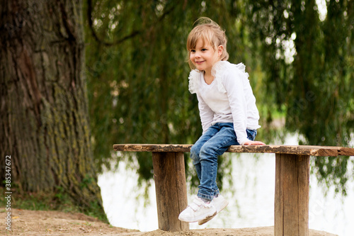 little girl sitting on bench