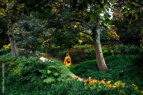 Photography AMSTERDAM, THE NETHERLANDS OCTOBER 07, 2020: Girl in a yellow coat walking throu