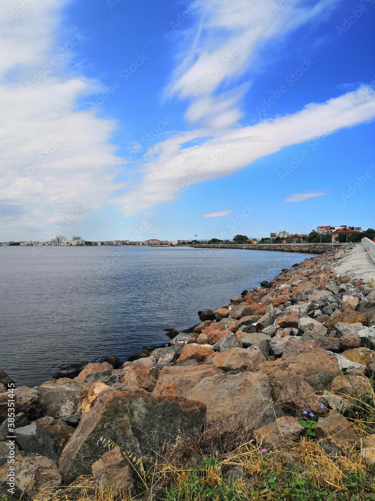 seashore with a stone embankment. The coast of the Black Sea. Embankment alley for walks. seashore with a stone embankment. The coast of the Black Sea. Embankment alley for walks.