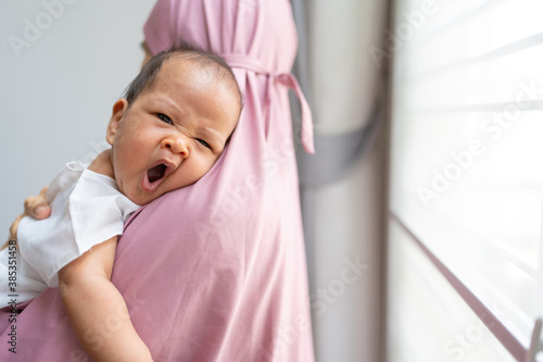 Canvas Print Muslim woman holding newborn baby in her arm