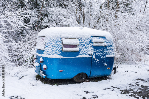 vintage camper trailer covered with snow