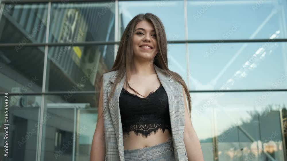Woman in stylish gray suit and open neckline near offices holding Woman in stylish gray suit and open neckline near offices holding
