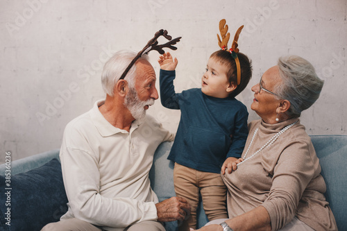 Old couple waring masks, looking through window