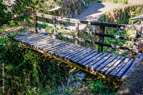 Very dilapidated wooden bridge in an abandoned village