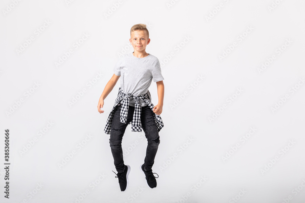 Cool teenage boy jumps in an empty room Cool teenage boy jumps in an empty room