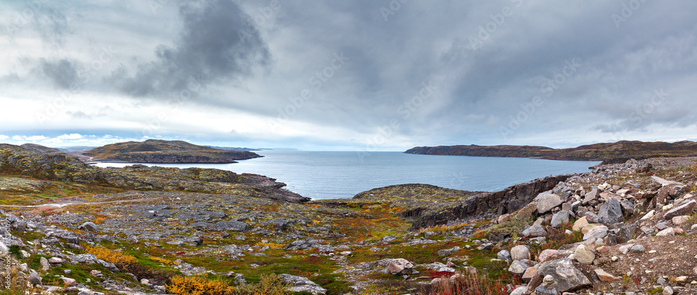 Panoramic views of the sea bay and rocky shores at low tide. Far North, Barents Sea in Russia. Panoramic views of the sea bay and rocky shores at low tide. Far North, Barents Sea in Russia.