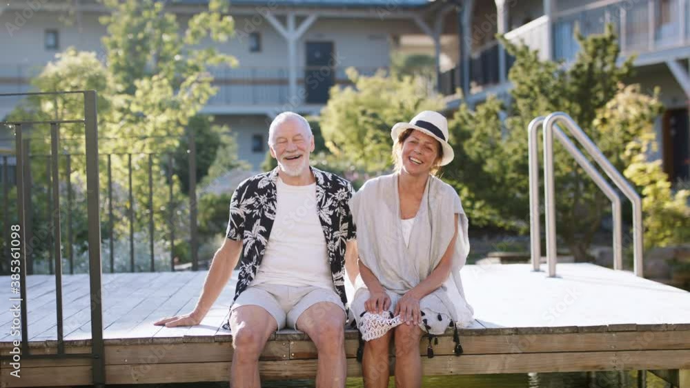 Senior couple resting outdoors on holiday, looking at camera. Senior couple resting outdoors on holiday, looking at camera.