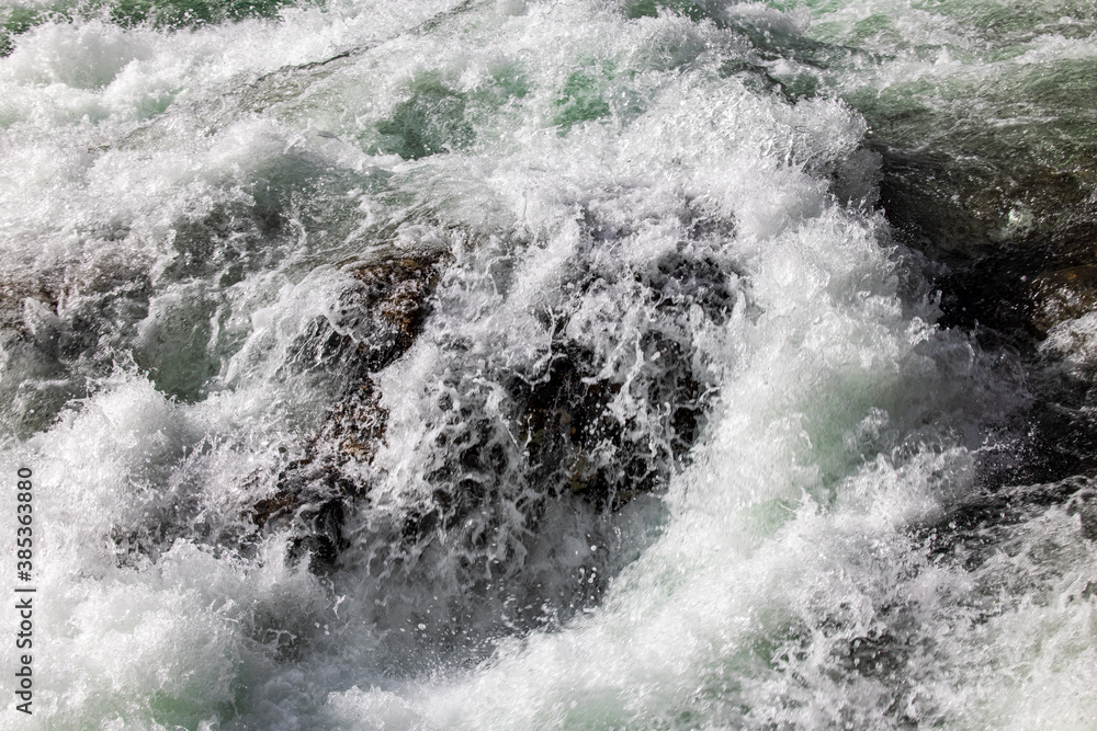 Closeup of waves crashing into rock