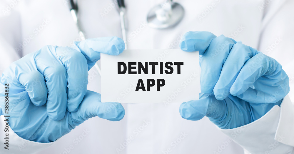 Doctor holding a card with text DENTIST APP, medical concept. Doctor holding a card with text DENTIST APP, medical concept.