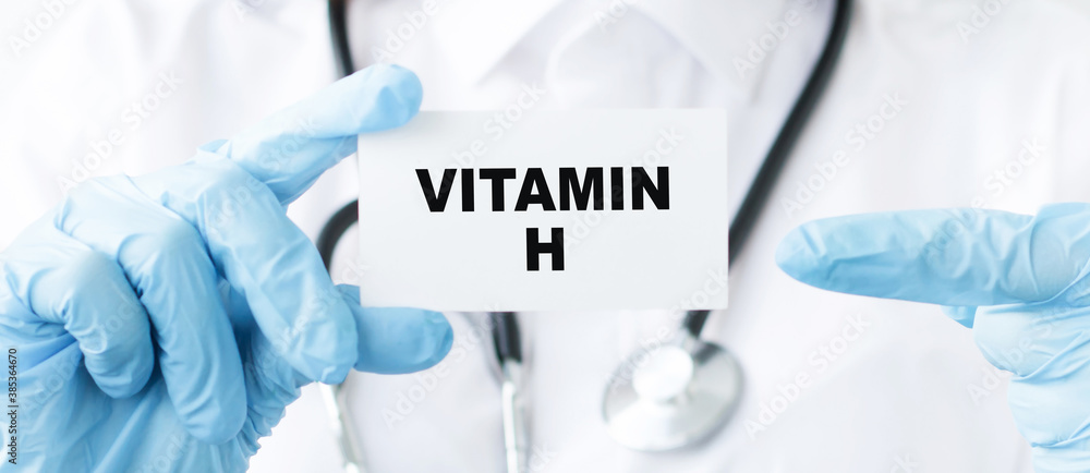 Close-up of female doctor holding a tablet with the text Vitamin H. Medical concept. Close-up of female doctor holding a tablet with the text Vitamin H. Medical concept.