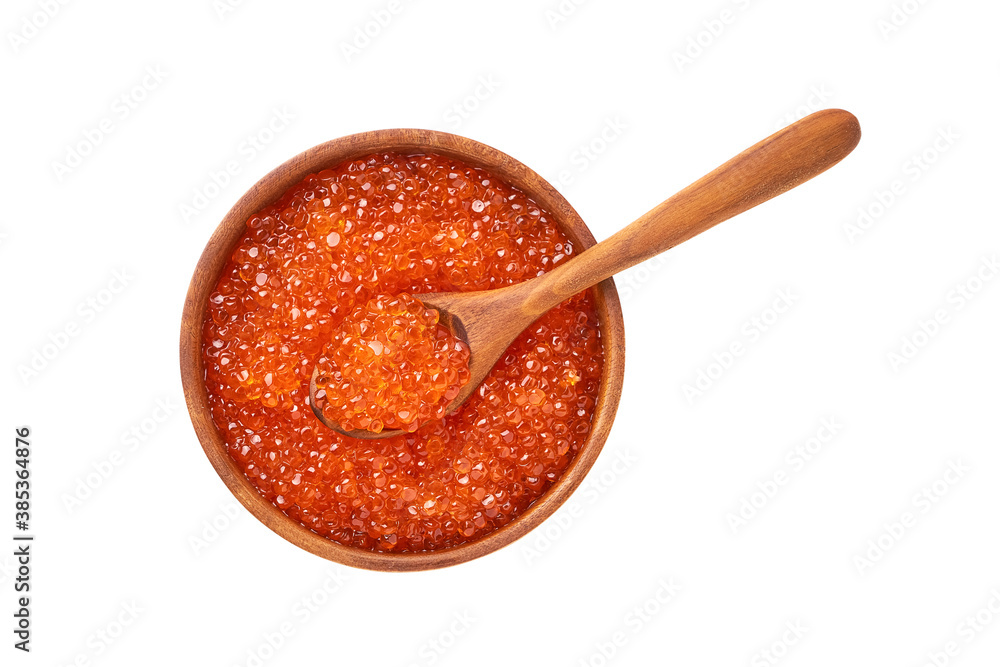 Red caviar in a wooden bowl and spoon with caviar isolated over white background. Top view