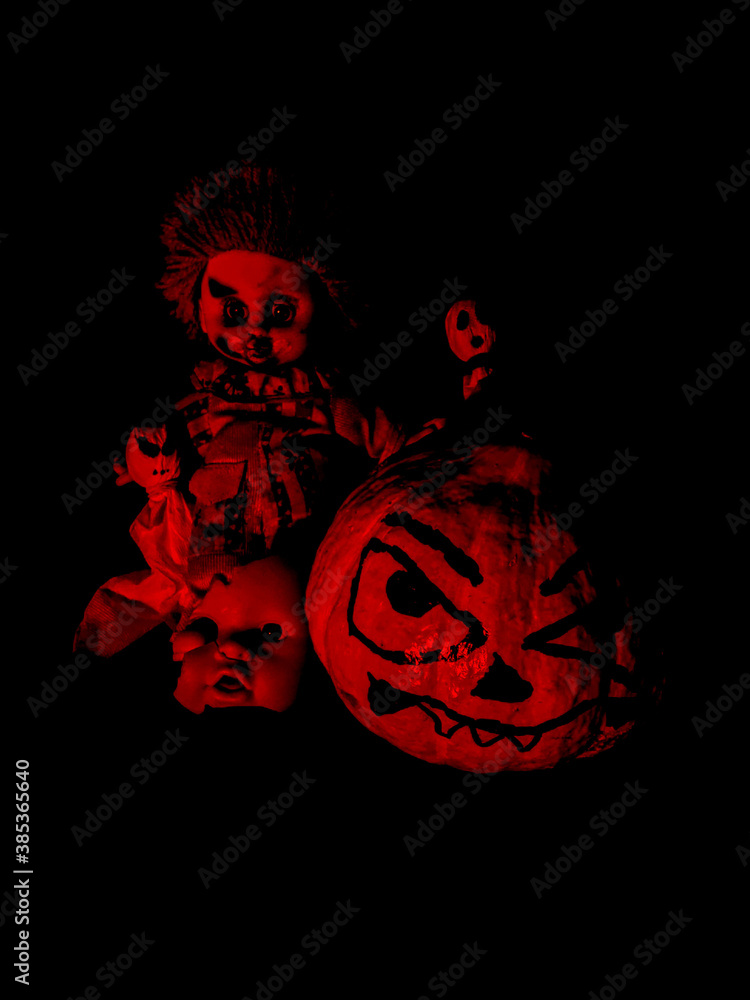 halloween scary pumpkin gang with ghosts and a scary clown and half a broken doll face under red and black lighting halloween scary pumpkin gang with ghosts and a scary clown and half a broken doll face under red and black lighting