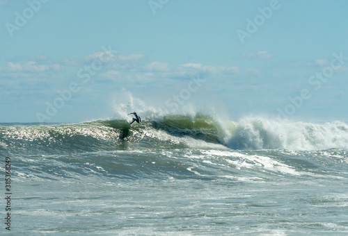 Single surfer rides a wave from Hurricane in Montauk © Brandon