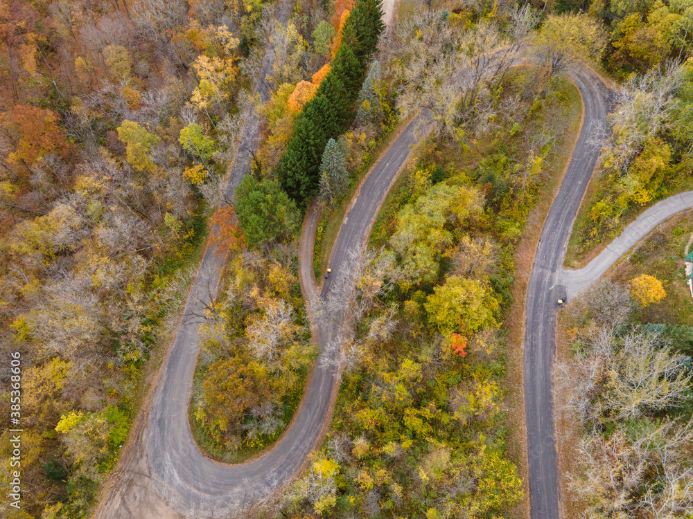 a winding road through the country hillside in the mountains during autumn