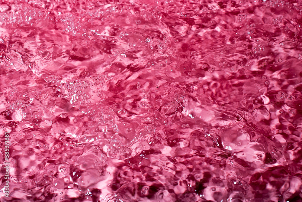 splash of water on a red background. Abstract wallpaper splash of water on a red background. Abstract wallpaper
