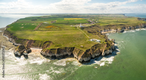 Aerial view of waves crashing on chalk cliffs along Selwicks Bay, UK. photo