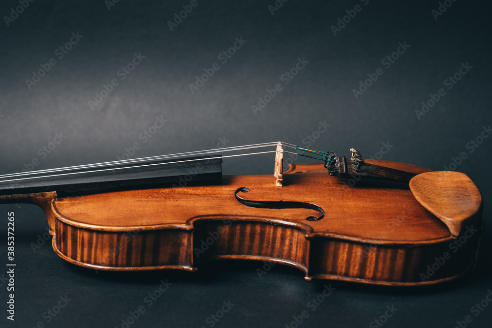 Fototapeta premium beautiful violin musical instrument on black background. High quality photo