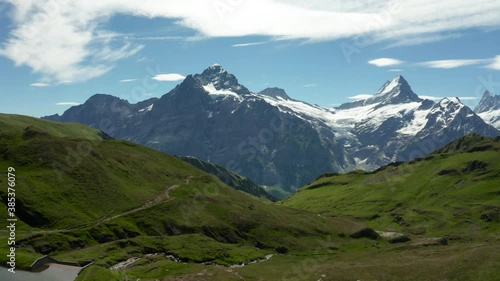 Wallpaper Mural aerial view of beautiful mountain scenery with snow covered high mountain peaks and green grass during Summer. Schreckhorn Grindelwad First, Switzerland Torontodigital.ca