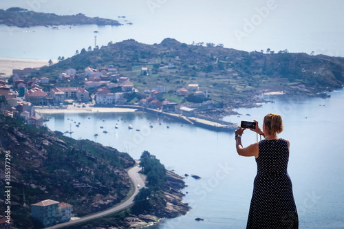 woman taking photos at the ezaro viewpoint in dumbria, la Coruña photo