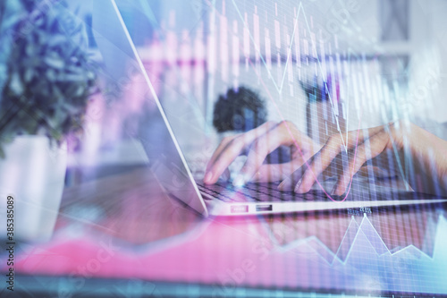 Double exposure of woman hands typing on computer and forex chart hologram drawing. Stock market invest concept. © peshkova