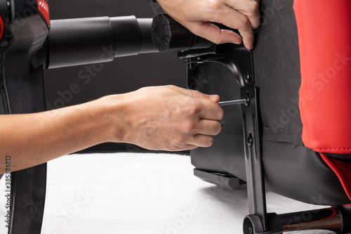 adjusting or repair office armchair. worker fixing arm chair. close up. diy concept