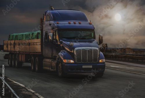 Large truck transports a grug along a road