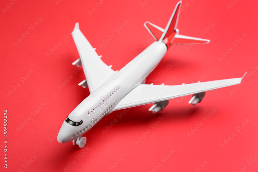 Toy airplane on red background, closeup. Travel concept Toy airplane on red background, closeup. Travel concept
