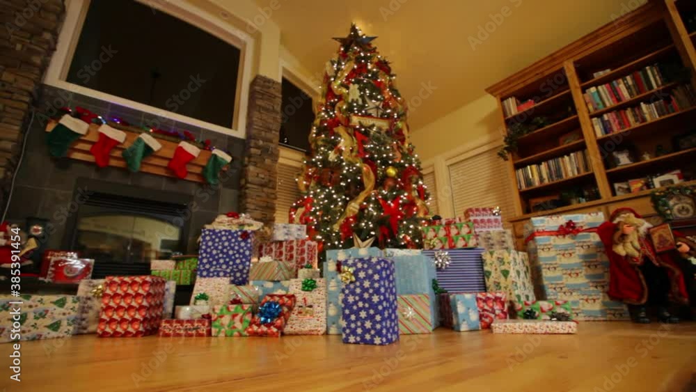 Dolly shot, low angle view of presents around Christmas tree