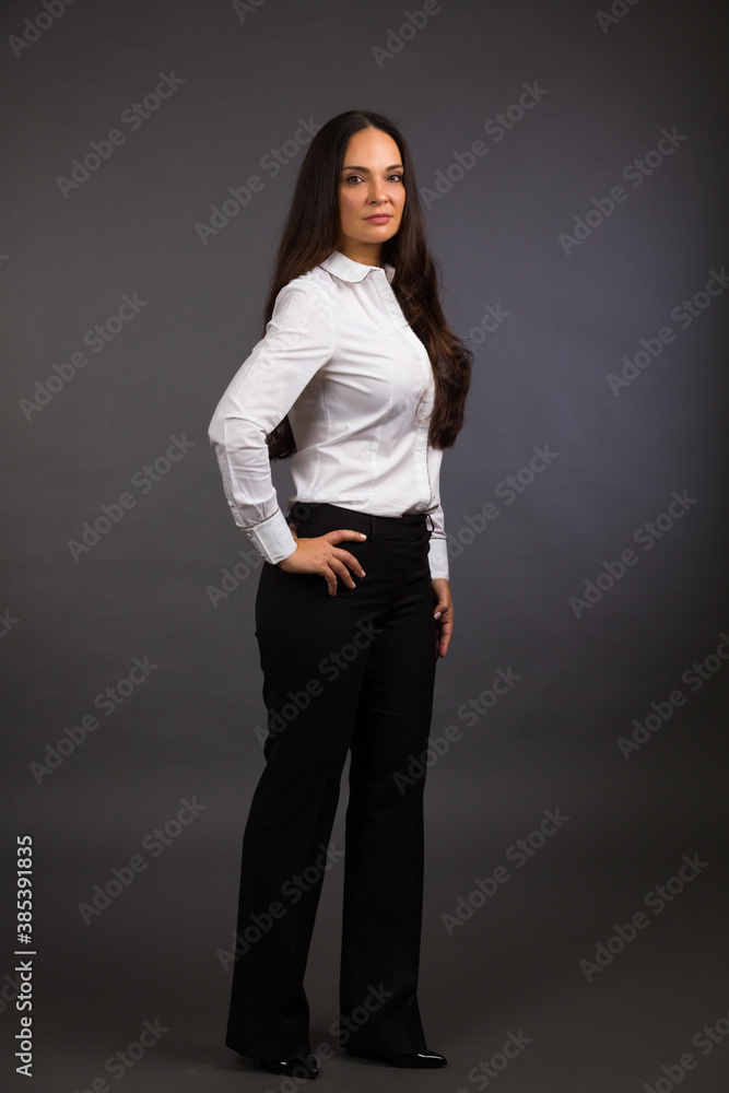 Beautiful young woman studio portrait on a gray background Beautiful young woman studio portrait on a gray background