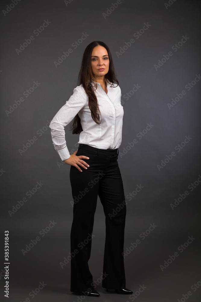 Beautiful young woman studio portrait on a gray background Beautiful young woman studio portrait on a gray background