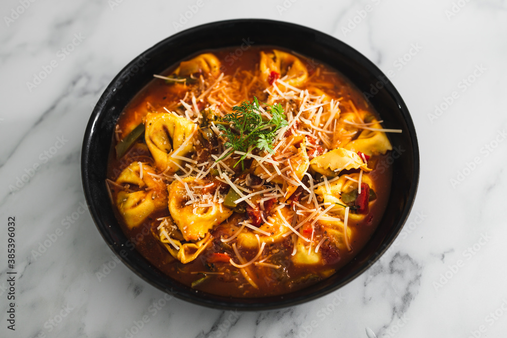plant-based food, vegan eggplant tortellini with tomato sauce and dairy-free parmesan