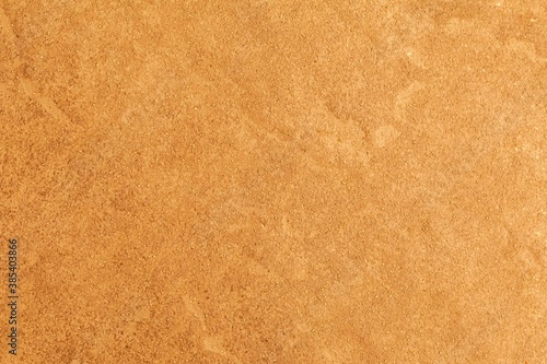 Rough patterned brown cement wall texture and seamless background