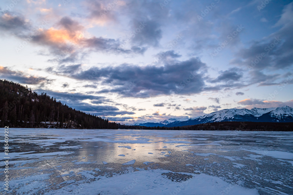 Mountains and trees seen from a frozen Pyramid Lake. Jasper, Alberta / Canada.
