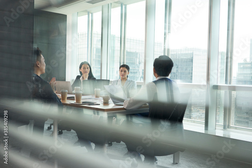Photography team of asian corporate executives discussing business in conference room