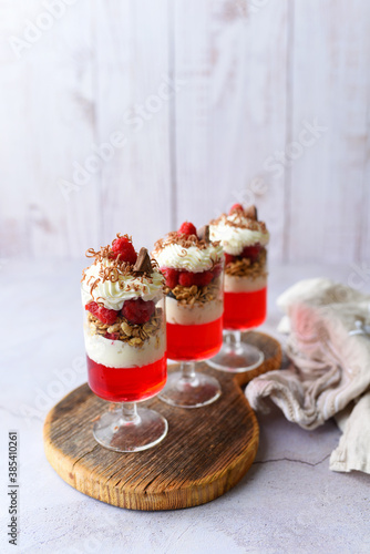 Dessert in a glass, raspberry jello with granola on yogurt and whipped topping 