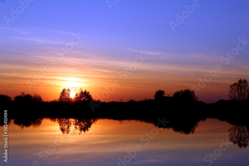 Bright sunset in summer over the lake