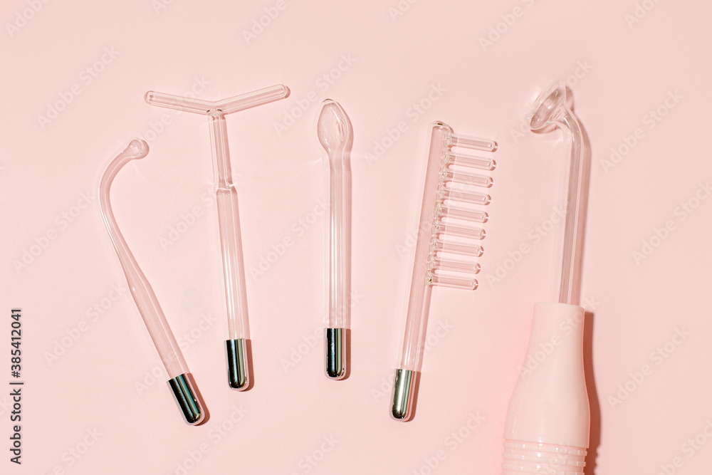 Darsonval on a pink background. Top view mockup with space for text. Darsonvalization. Cosmetology. Microcurrent therapy, wellness, self care concept, beauty routine for skin, body and hair Darsonval on a pink background. Top view mockup with space for text. Darsonvalization. Cosmetology. Microcurrent therapy, wellness, self care concept, beauty routine for skin, body and hair