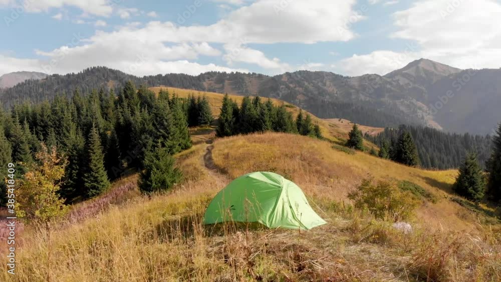 Green camping tent in the mountain forest Green camping tent in the mountain forest