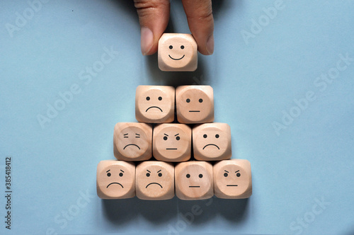 Image of different emotions on wooden cubes. Choice of positive emotions.