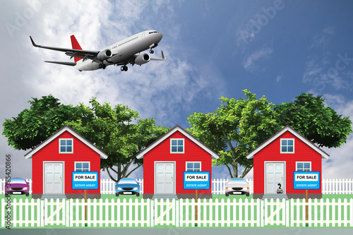 Row of detached residential homes for sale due to noise levels from low flying commercial aircraft from a nearby airport set against a blue cloudy sky