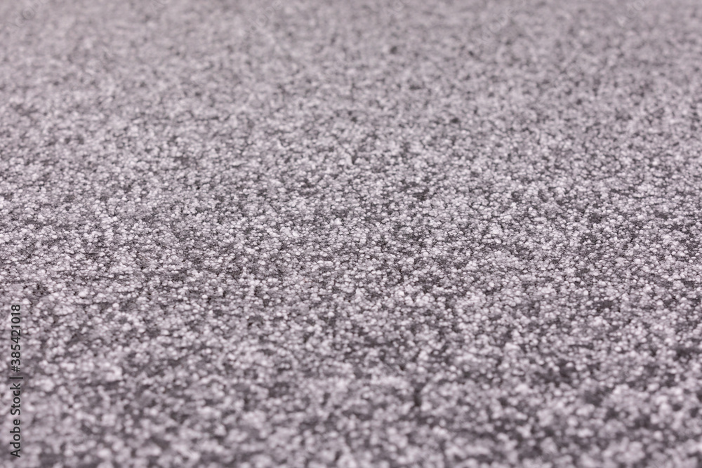 Think layer of hail on a surface of black trampoline Think layer of hail on a surface of black trampoline